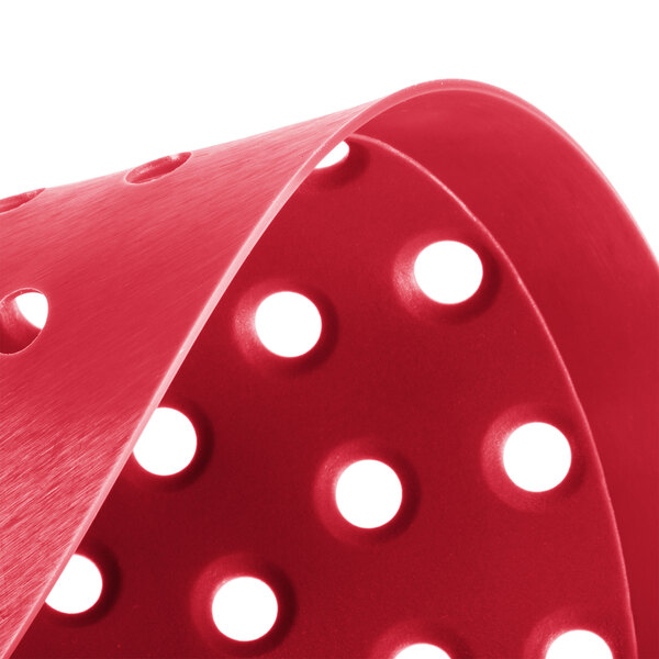 A red plastic Lavex urinal screen with holes in it.