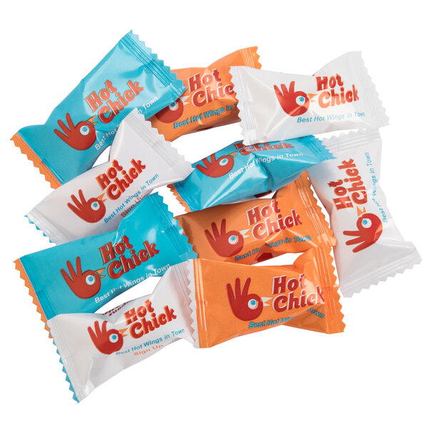 A close-up of a group of small packages of Customizable Assorted Fruit Balls with a blue and red label.