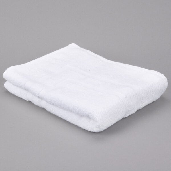 A white Oxford Miasma bath mat on a gray surface.