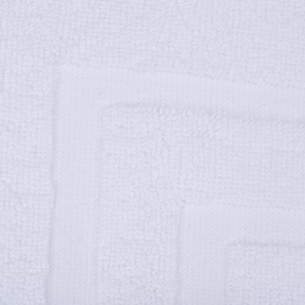A white bath mat with a square design.