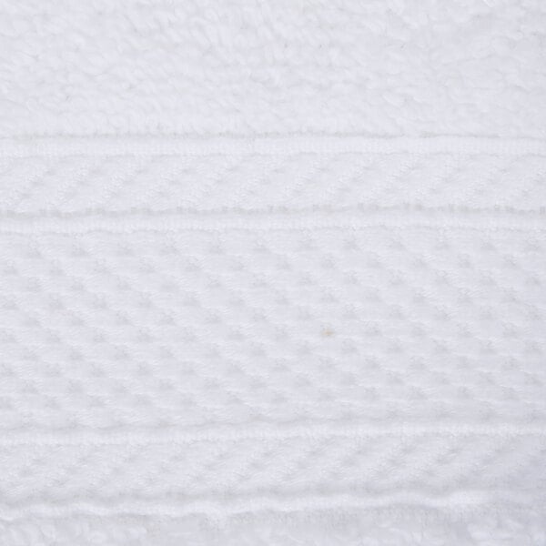 A close up of a white towel with a pattern.