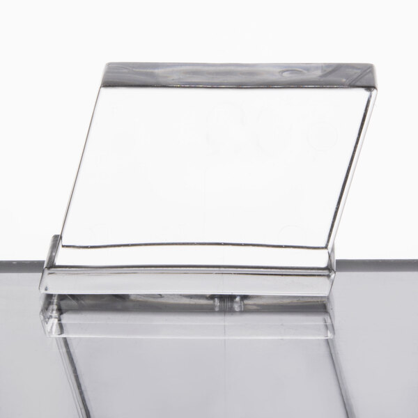 A Manitowoc Indigo series air cooled half size cube ice machine with a clear surface.