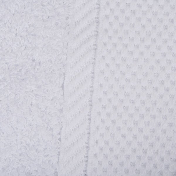 A close up of a white Oxford Miasma bath towel with a white border.