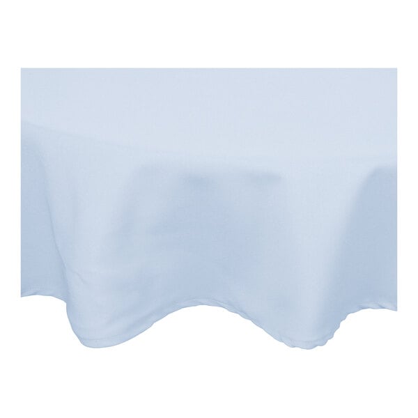 A round table with a light blue Intedge tablecloth.