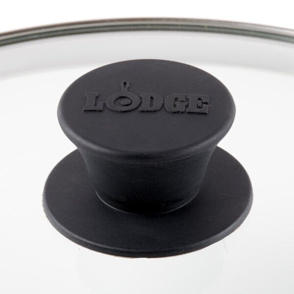 A black Lodge lid on a glass pan.