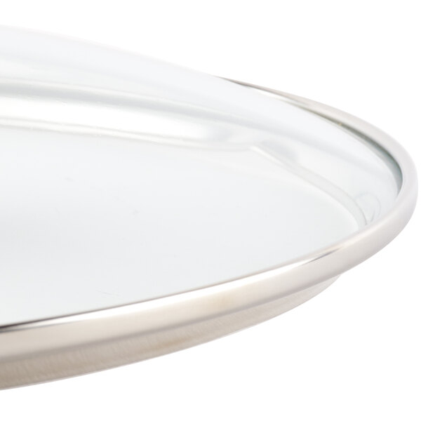 A Lodge tempered glass cover with a metal rim.