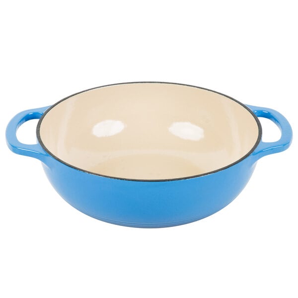 A Caribbean blue and white enameled cast iron pot with two handles.