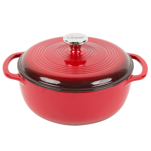 A Lodge Island Spice Red Enameled Cast Iron Dutch Oven with a lid.