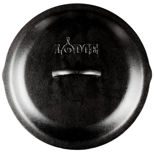 A Lodge black cast iron lid with a handle.