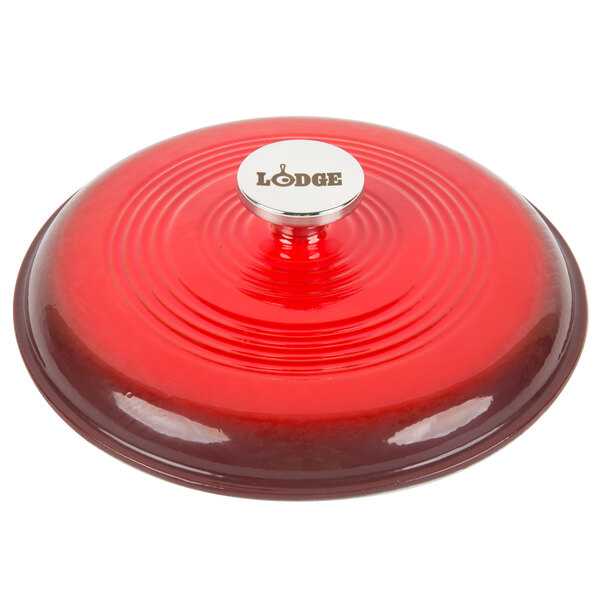 The lid for a Lodge Island Spice Red Enameled Cast Iron Dutch Oven with a silver knob.