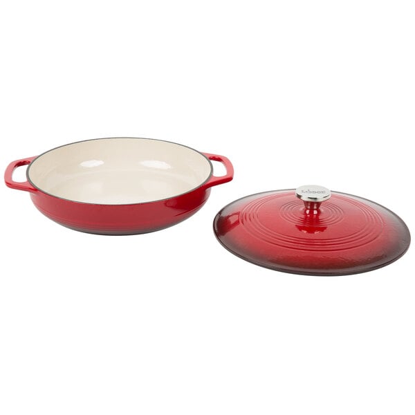 A red and white Lodge enameled cast iron casserole dish with lid.