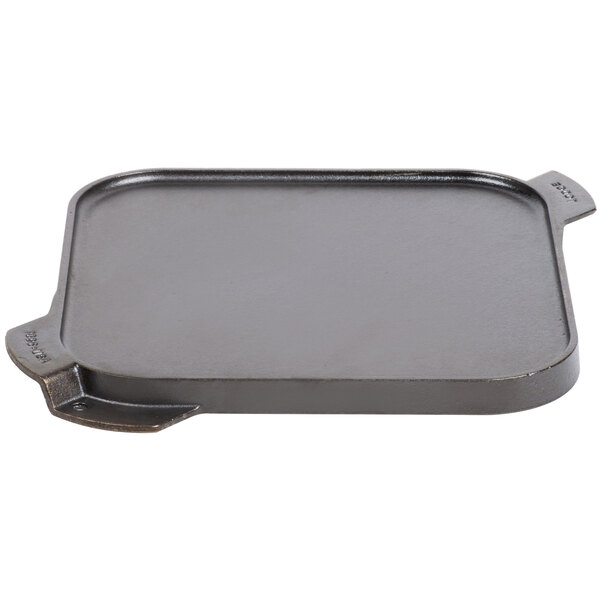 A Lodge rectangular cast iron griddle and grill pan with handles.