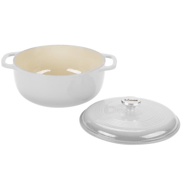 A white Lodge enameled cast iron dutch oven with a silver lid.