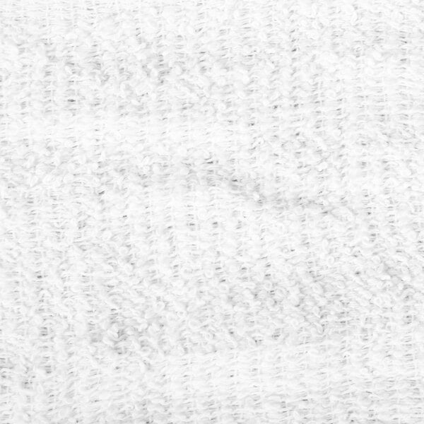 A close-up view of a white, textured, terry cloth fabric.