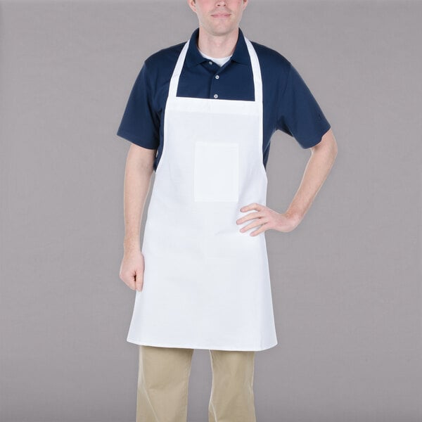 A man wearing a white Chef Revival bib apron.