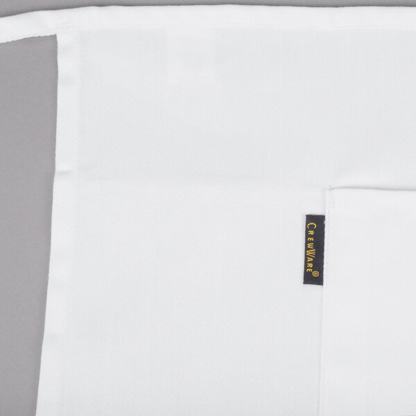 A white Chef Revival bistro apron with two pockets and a black tag.