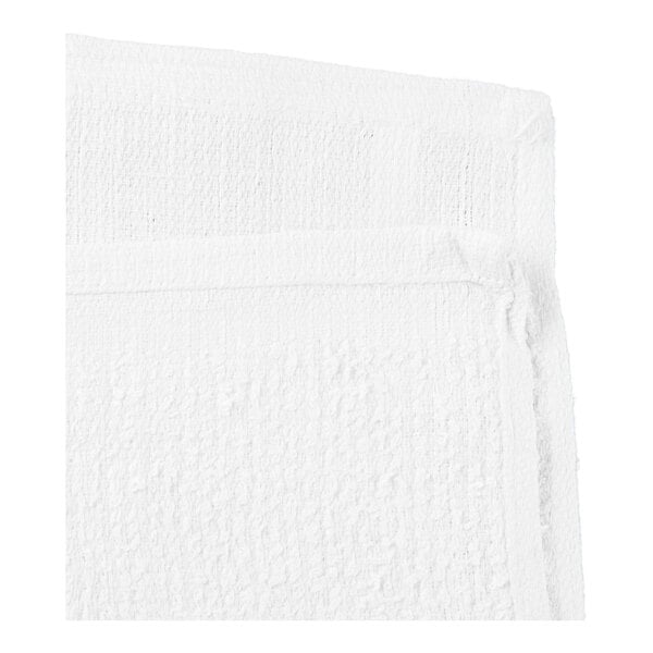 A close-up view of two white ribbed cotton towels stacked together.