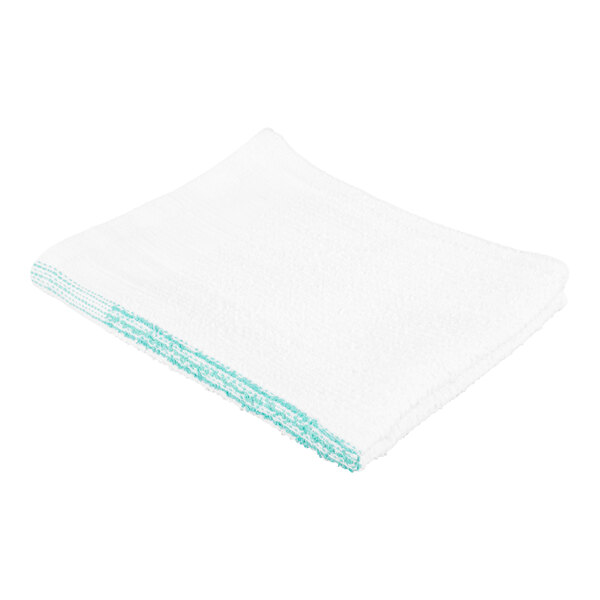 A white towel with green stripes along one edge, folded neatly.