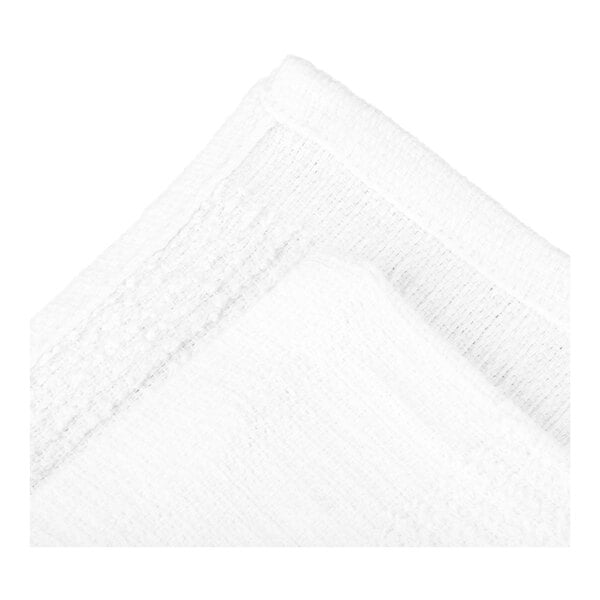 A close-up view of a white textured fabric with visible stitching along the edges.