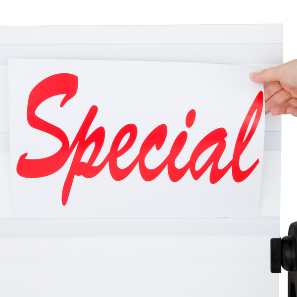 A person using an Aarco white roadside letterboard to hold a sign.