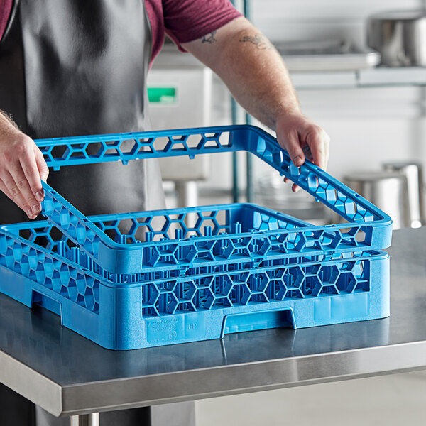 A man holding a blue plastic basket with a handle.