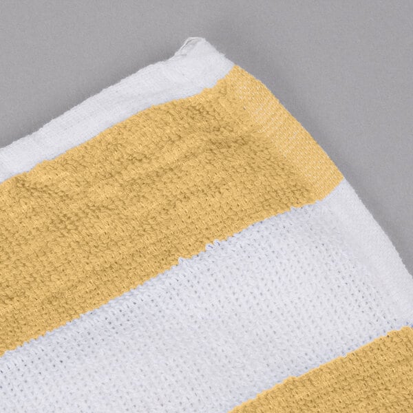 An Oxford yellow and white striped pool towel.