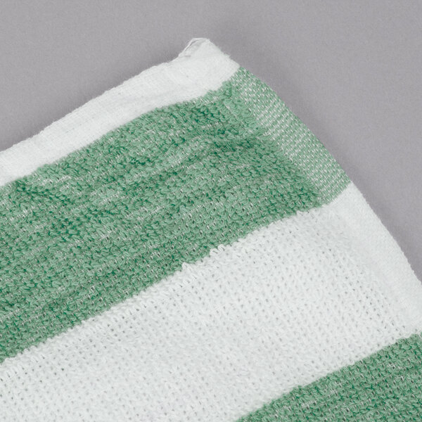 An Oxford green and white striped pool towel.