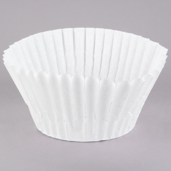A white Grindmaster coffee filter on a white surface.