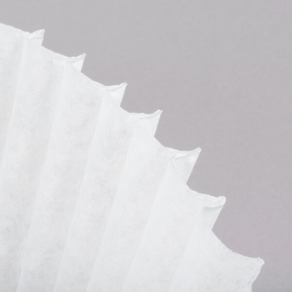 A close up of a white paper coffee filter.