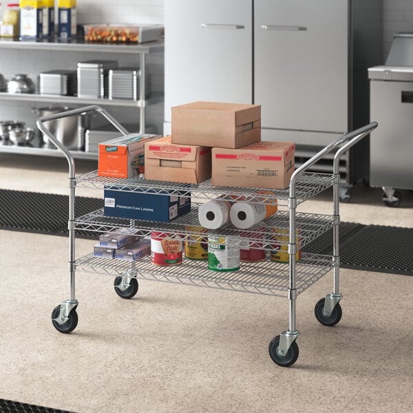 A Regency chrome utility cart with boxes on it.