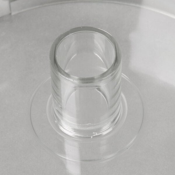 A clear Robot Coupe cutter bowl on a white surface