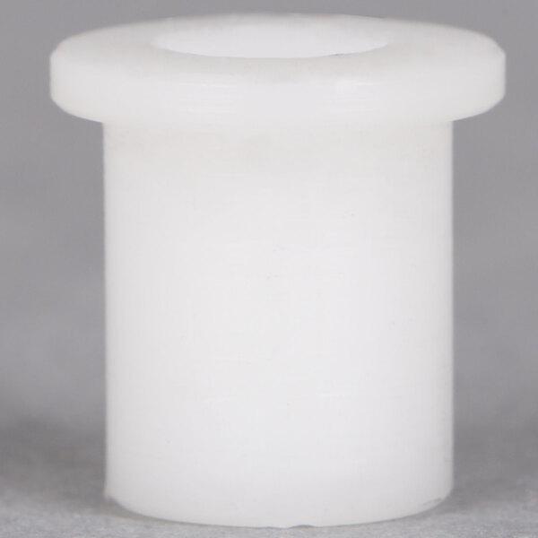 A white plastic cylinder with a hole in it.