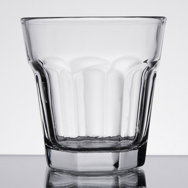 An Anchor Hocking clear glass with a black rim.