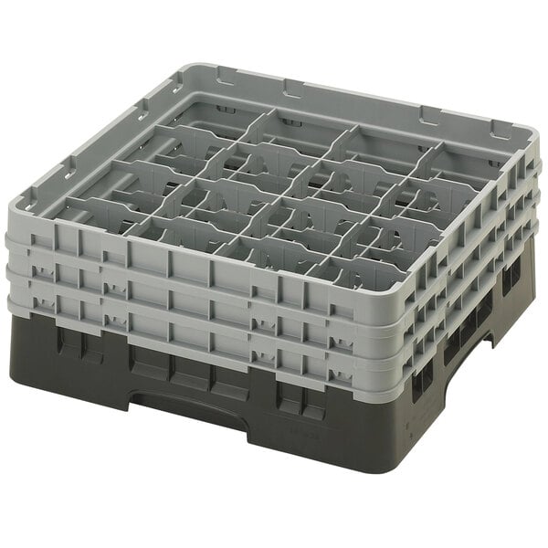 A black plastic Cambro glass rack with 16 compartments and 3 extenders.