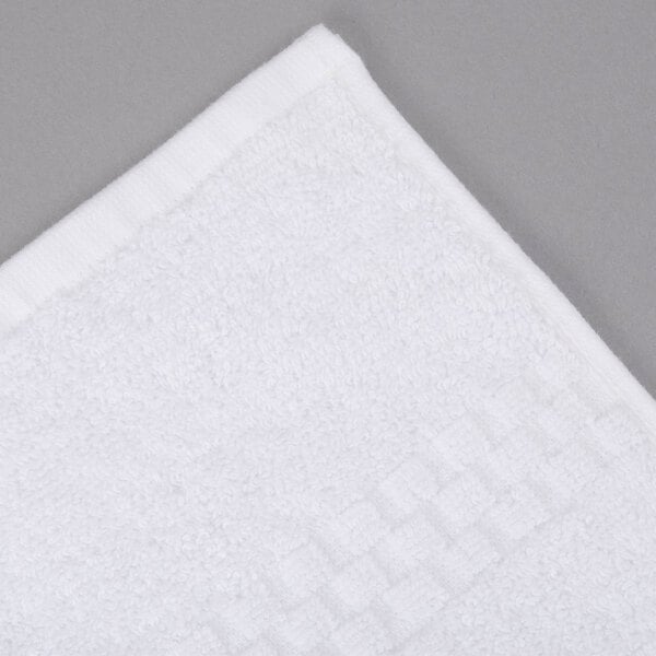 A close-up of a white Oxford Viceroy pool towel with a square design.