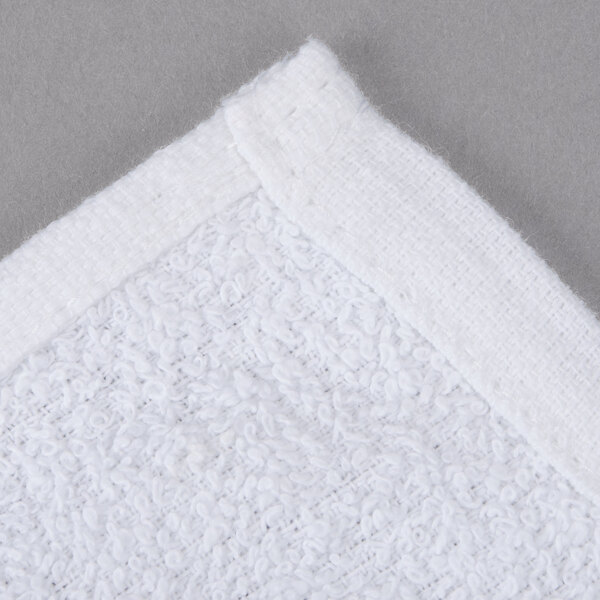 An Oxford Gold white cotton/poly wash cloth with a hemmed white edge.