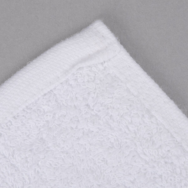 An Oxford Gold white bath towel with a white cam border.