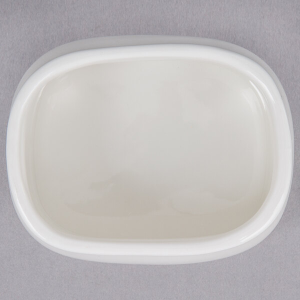 An American Metalcraft porcelain sugar packet holder on a gray surface.