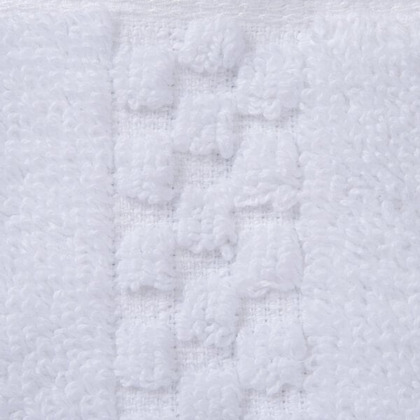 A close up of a white Oxford Viceroy washcloth with a dobby checkered pattern.