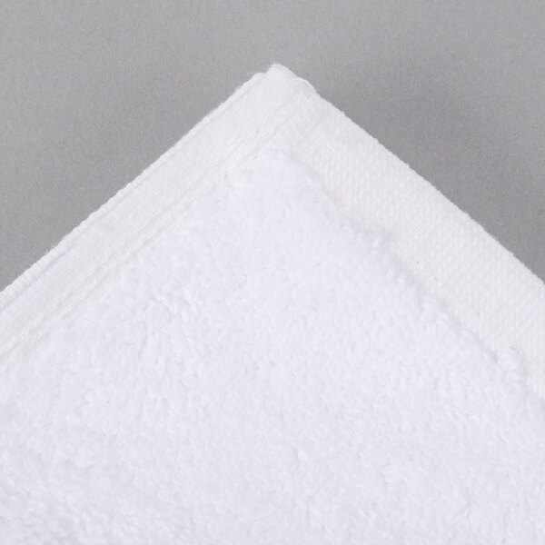 A white Oxford Regale bathmat with a white dobby border and corner.