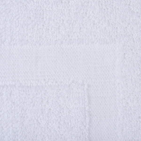 A close up of an Oxford Regale white bathmat with a square dobby border.