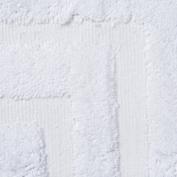 A close-up of an Oxford Regale white bathmat with a dobby border and hem.