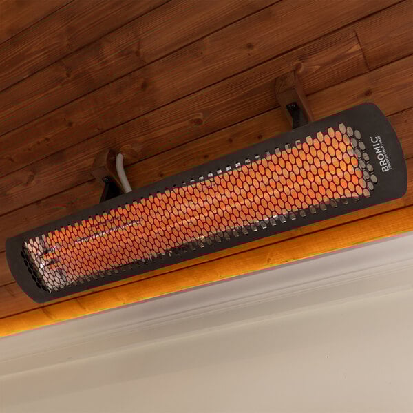 A black electric outdoor patio heater mounted on a wooden ceiling.