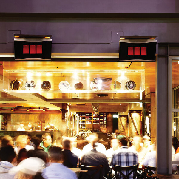 A pair of Bromic Heating Platinum Smart-Heat 300 Series natural gas outdoor patio heaters mounted above a restaurant patio area.