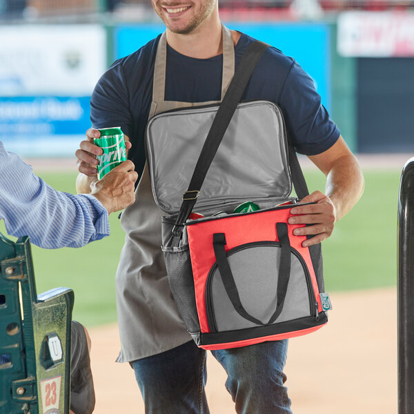 A man holding a Choice red insulated cooler bag.