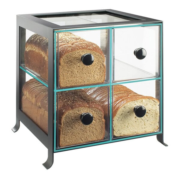 A black steel bread case with four clear drawers, each holding a loaf of bread.