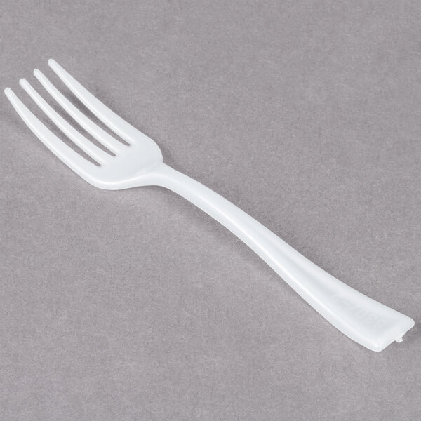 A small white plastic fork with four tines is shown on a gray surface.