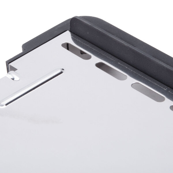 A close up of a metal crumb tray with a hole in it.