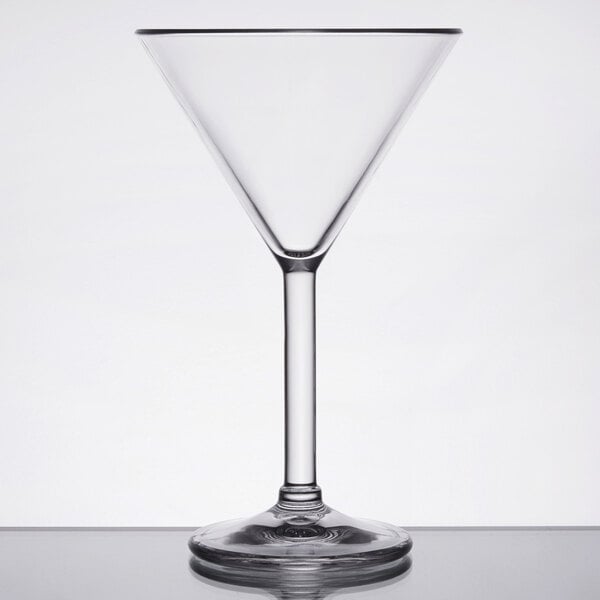 A clear plastic martini glass with a long stem.
