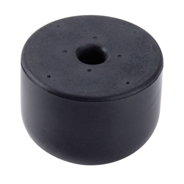 A black round rubber foot with a hole in it.